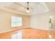 Comfortable main bedroom featuring hardwood floors, neutral walls, and a doorway to the en-suite bathroom at 155 Skyview Dr, Social Circle, GA 30025