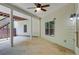 Covered patio with stairs to backyard, overhead ceiling fan, concrete floor, and side door at 155 Skyview Dr, Social Circle, GA 30025