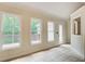 Sunroom features tiled floors, white trim, three large windows, and a glass door to the deck at 155 Skyview Dr, Social Circle, GA 30025