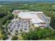 This aerial view highlights school's extensive facilities surrounded by wooded areas, including parking lots and athletic fields at 390 Scott Farm Dr, Powder Springs, GA 30127
