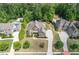 Aerial view of a beautiful home with mature landscaping, a long driveway, and a well-manicured lawn at 390 Scott Farm Dr, Powder Springs, GA 30127
