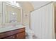 Bathroom featuring vanity, toilet, shower with shower curtain, and large mirror at 390 Scott Farm Dr, Powder Springs, GA 30127