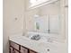 Bathroom with double sinks, a large mirror, and white cabinets at 390 Scott Farm Dr, Powder Springs, GA 30127