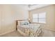 Comfortable bedroom with a window, a ceiling fan, and a plush carpet at 390 Scott Farm Dr, Powder Springs, GA 30127