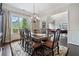 Formal dining room with hardwood floors, elegant chandelier, and views to the living area at 390 Scott Farm Dr, Powder Springs, GA 30127