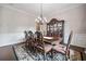Formal dining room with a large table, decorative china cabinet, and elegant chandelier at 390 Scott Farm Dr, Powder Springs, GA 30127