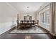 Bright dining room with a large window, hardwood floors, and an elegant chandelier at 390 Scott Farm Dr, Powder Springs, GA 30127