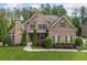 Beautiful brick home with manicured lawn, mature landscaping, and inviting curb appeal at 390 Scott Farm Dr, Powder Springs, GA 30127