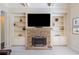 Close up of fireplace with stone surround and built-in shelving units at 390 Scott Farm Dr, Powder Springs, GA 30127