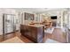 An open-concept kitchen with island seating that connects to living and dining areas at 390 Scott Farm Dr, Powder Springs, GA 30127