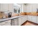 Bright kitchen with stainless appliances, granite countertops, tile backsplash, and wood floors at 390 Scott Farm Dr, Powder Springs, GA 30127