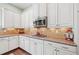 A gourmet kitchen featuring granite counters, stainless appliances, and white cabinetry at 390 Scott Farm Dr, Powder Springs, GA 30127