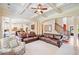 Open concept living room with coffered ceiling, hardwood floors, and staircase in the background at 390 Scott Farm Dr, Powder Springs, GA 30127