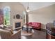 Cozy living room featuring a fireplace, large windows, and comfortable seating area at 390 Scott Farm Dr, Powder Springs, GA 30127