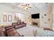 Living room with stone fireplace, built-in bookshelves, and coffered ceiling at 390 Scott Farm Dr, Powder Springs, GA 30127