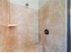 Tiled walk-in shower featuring a corner bench, shower head, and glass door at 390 Scott Farm Dr, Powder Springs, GA 30127