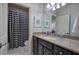 Well-lit bathroom with black cabinets, granite countertop, and a tiled shower at 16 Cambridge Way, Cartersville, GA 30121