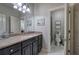 Bright bathroom featuring a granite countertop, black cabinets, and a tiled shower at 16 Cambridge Way, Cartersville, GA 30121