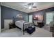 Serene bedroom with blue accents, a ceiling fan, and two windows at 16 Cambridge Way, Cartersville, GA 30121
