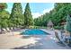 Inviting community pool surrounded by lounge chairs and lush landscaping for relaxation and enjoyment at 16 Cambridge Way, Cartersville, GA 30121