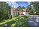 Charming two-story home featuring a lush green lawn, a covered front porch and beautiful architectural details at 16 Cambridge Way, Cartersville, GA 30121