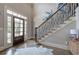 Elegant foyer with hardwood floors, staircase, and a front door with sidelights allowing plenty of natural light at 16 Cambridge Way, Cartersville, GA 30121