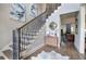 Bright foyer with hardwood floors, elegant staircase, and stylish decor, offering a warm welcome into the home at 16 Cambridge Way, Cartersville, GA 30121