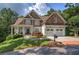 Beautiful two-story home with a brick driveway, two-car garage, and a nicely landscaped front yard at 16 Cambridge Way, Cartersville, GA 30121