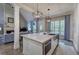 Modern kitchen with an island, stainless steel appliances, and open access to the living room, perfect for entertaining at 16 Cambridge Way, Cartersville, GA 30121