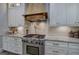 Close up of the stainless steel stove and hood vent in the kitchen at 16 Cambridge Way, Cartersville, GA 30121