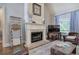 Cozy living room featuring a fireplace, mantel decorations, and a comfortable seating area, perfect for relaxation at 16 Cambridge Way, Cartersville, GA 30121