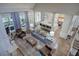 Spacious living room featuring comfortable seating, hardwood floors, kitchen, and access to screened porch at 16 Cambridge Way, Cartersville, GA 30121