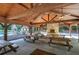 Spacious outdoor pavilion featuring a stone fireplace, ceiling fans, and several picnic tables at 16 Cambridge Way, Cartersville, GA 30121