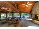 Community pavilion with stone fireplace and wood ceilings adjacent to a pool and picnic tables at 16 Cambridge Way, Cartersville, GA 30121