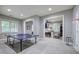Spacious recreation room with ping pong table, view to office, and basketball hoop for versatile enjoyment at 16 Cambridge Way, Cartersville, GA 30121