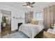 Bedroom showcasing a cozy bed, original hardwood floors, and an ornamental fireplace at 818 Virgil Ne St, Atlanta, GA 30307