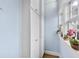 Hallway with white storage cabinets and a window with potted plants at 818 Virgil Ne St, Atlanta, GA 30307