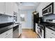 Well-lit kitchen with white cabinets, black countertops, and stainless steel appliances, perfect for culinary enthusiasts at 818 Virgil Ne St, Atlanta, GA 30307
