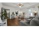 Bright living room featuring hardwood floors, a comfortable gray sofa, and an open view to the kitchen and bathroom at 818 Virgil Ne St, Atlanta, GA 30307