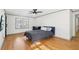 Bright bedroom with hardwood floors, large window, and a modern ceiling fan at 8671 Lake Forrest Dr, Douglasville, GA 30134