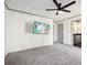 Large bedroom featuring neutral carpet, a ceiling fan, and ensuite bath access at 8671 Lake Forrest Dr, Douglasville, GA 30134