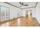 Bright living room with hardwood floors, two shuttered windows, and light gray trim at 8671 Lake Forrest Dr, Douglasville, GA 30134