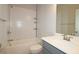A bathroom featuring white subway tile, gray vanity, modern fixtures, and a combination shower and tub at 2163 Wiggins Walk, Atlanta, GA 30316