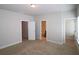 Spacious bedroom with neutral carpet, showing doorways to a bathroom and closet at 2163 Wiggins Walk, Atlanta, GA 30316