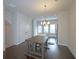 Dining room next to kitchen features sleek hardwood floors and a modern light fixture at 2163 Wiggins Walk, Atlanta, GA 30316