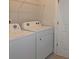 Well-lit laundry area equipped with modern washer and dryer units, plus shelving at 2163 Wiggins Walk, Atlanta, GA 30316