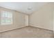 A vacant bedroom with a window and ceiling fan at 2197 Spring Walk Ct, Atlanta, GA 30341