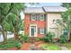 Charming townhome featuring brick facade, complemented by mature landscaping and a welcoming entrance at 2197 Spring Walk Ct, Atlanta, GA 30341