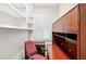 A compact home office featuring built-in desk, cabinets, shelving and a window with shutter blinds at 2197 Spring Walk Ct, Atlanta, GA 30341