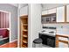 Practical kitchen with laminate countertops, classic white appliances, and built-in pantry at 2197 Spring Walk Ct, Atlanta, GA 30341